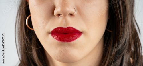 Close-up lips of young beautiful woman. Sexy red lips. Lip Makeup. Glossy red lipstick. Panoramic shot. Close-up macro shot. High quality image. Panorama banner.