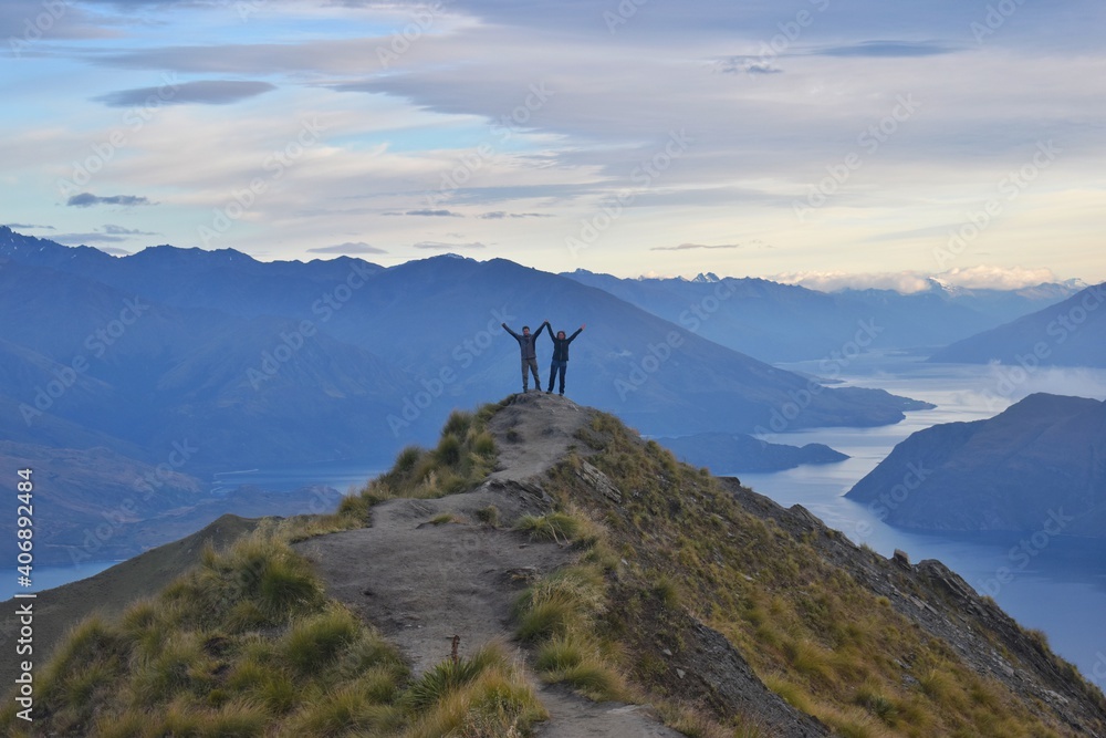 New Zealand, welcoming a new day from Roys Peak. The view to Lake Wanaka and mountains around is just breathtaking! This track is popular one day hike and definitely worth it. - obrazy, fototapety, plakaty 