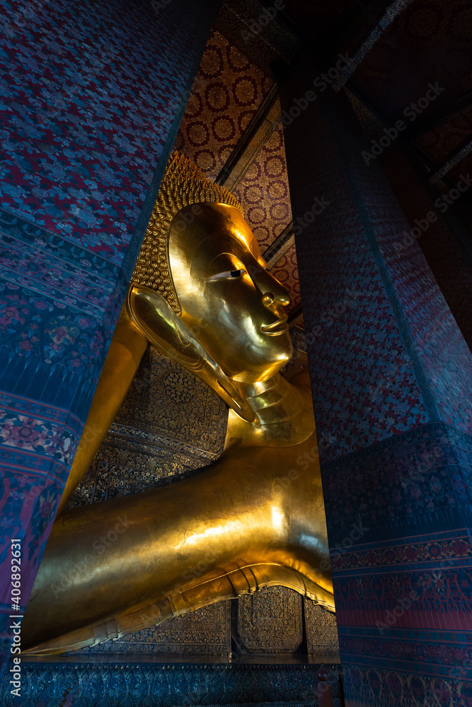 Beautiful big golden Reclining Buddha with in Wat Pho the Thai art architecture famous place and travel attraction at Bangkok, Thailand.