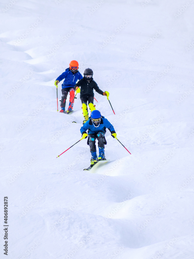 People are enjoying mogul skiing and snow boarding	