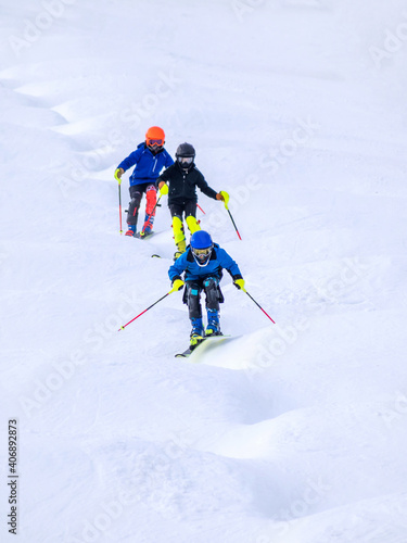 People are enjoying mogul skiing and snow boarding 