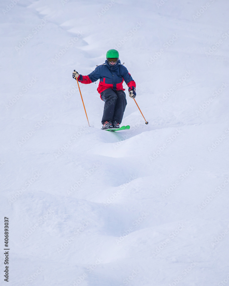 People are enjoying mogul skiing and snow boarding	