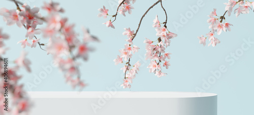 White product display podium with blossom flowers on blue background. 3D rendering 	