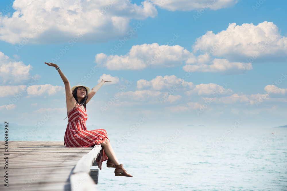 Fototapeta premium Happy lifestyle asian woman in sea beach, relax on the beach in summer. Travel Concept