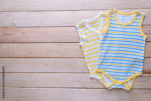 The clothing for kids for babies set on the wooden table.