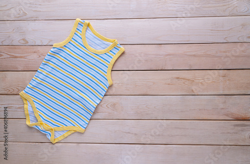 The clothing for kids for babies set on the wooden table.