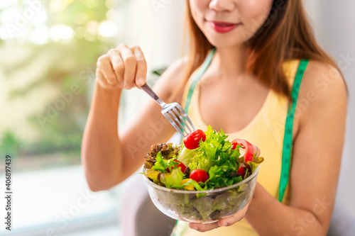 Young woman eating homemade healthy salad at home, Healthy eating lifestyle and diet concept