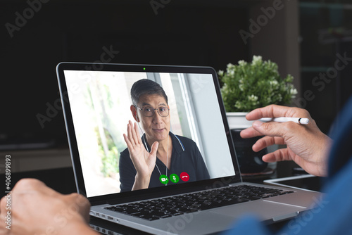 Video conference, work from home concept. Business man making video call using zoom online meeting app via laptop computer