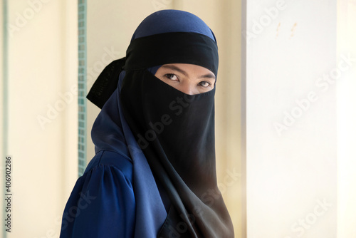 Portrait of islamic woman, Muslim woman wearing Nigab looking at camera at outdoor