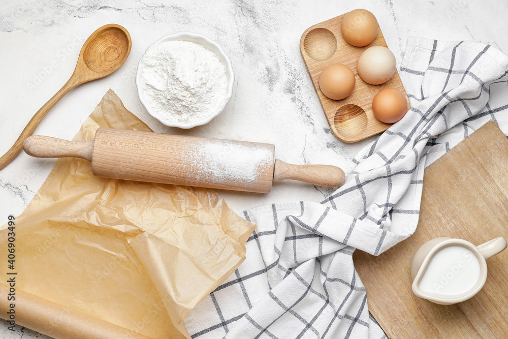 Ingredients for dough and rolling pin on light background Ingredients for dough and rolling pin on light background