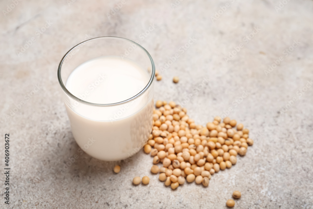 Glass of tasty soy milk on color background Glass of tasty soy milk on color background