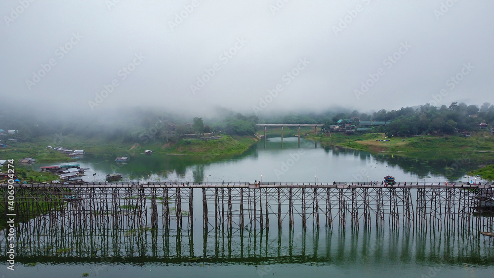 Landscape of old wooden mon bridge and foggy in the morning, Sangkhlaburi, Thailand.
