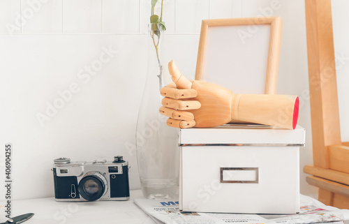 Wooden hand with box and ph...
