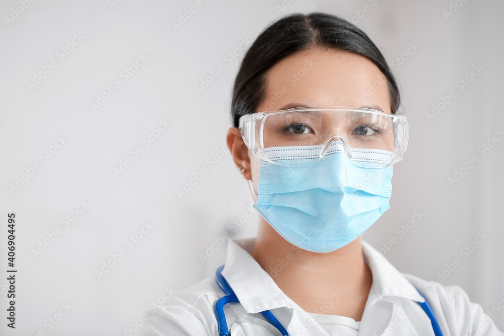 Portrait of female Asian doctor wearing medical mask in clinic Portrait of female Asian doctor wearing medical mask in clinic
