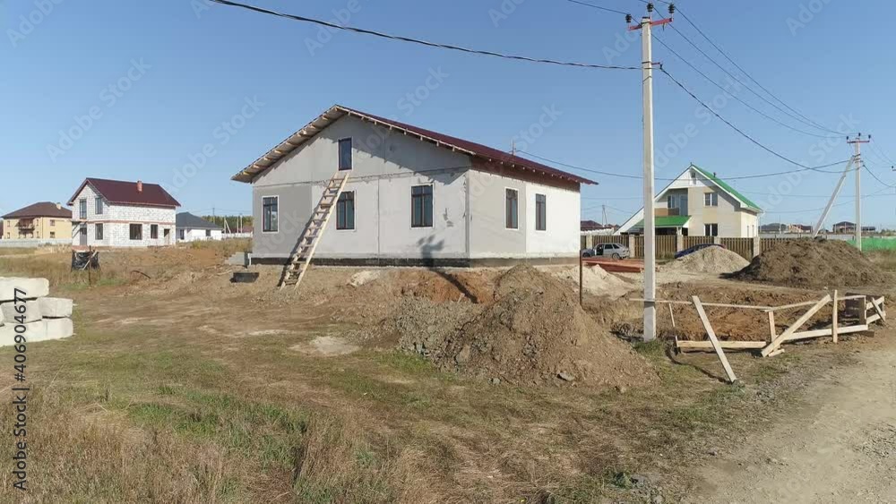 Aerial view of façade of unfinished modern energy efficient house of foam blocks panels with roof with metal tile sheets. House in village. Sunny day
Aerial view of façade of unfinished modern energy efficient house of foam blocks panels with roof with metal tile sheets. House in village. Sunny day