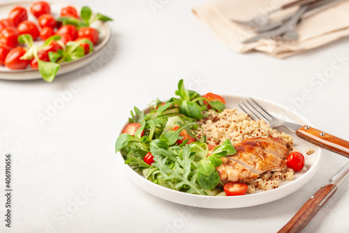 Turkey fillet or chicken, quinoa and vegetable salad in plate. Diet concept food.