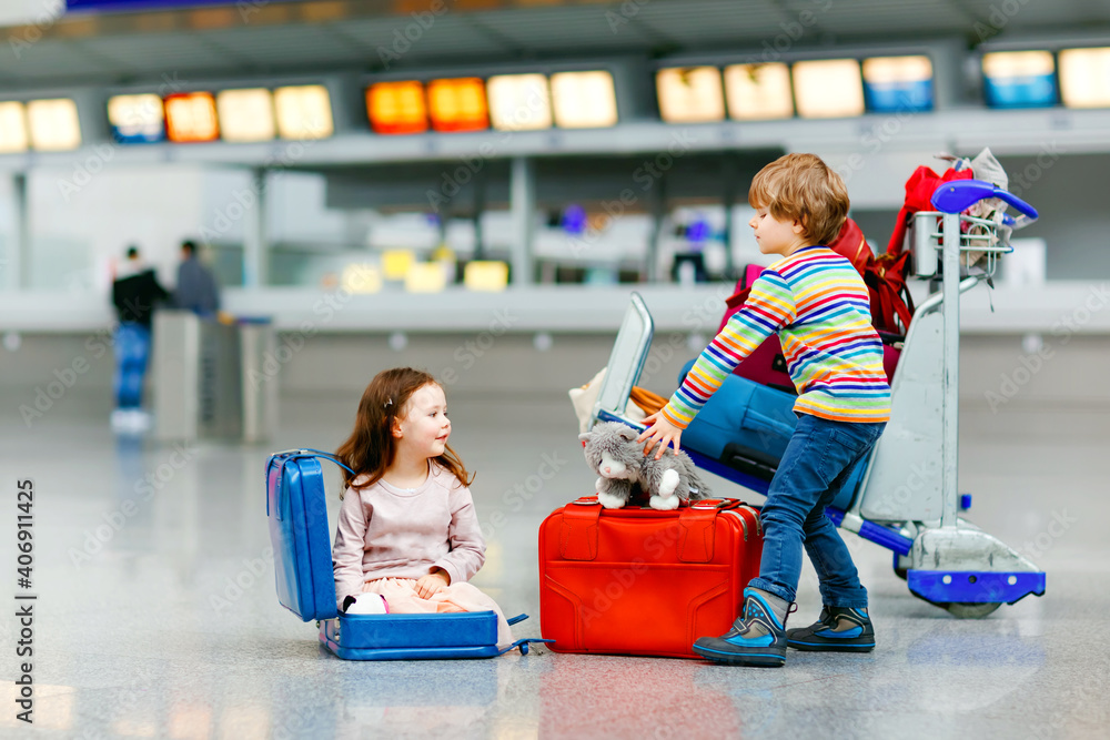 Kidd Rding Inside A Shuttle Cute little girl and boy at airport. Tired children, siblings sitting ...