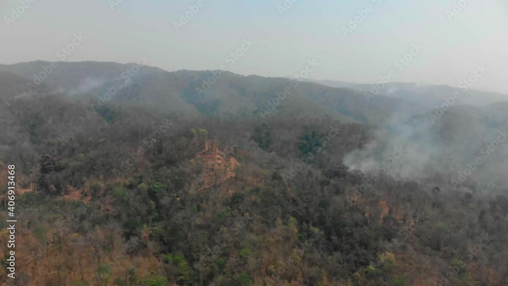 Smoke pollution problem from burning tree leaves with fire in green forest and mountain in the Asian country with Smoke pollution problem from burning tree leaves with fire in green forest and mountain in the Asian country with