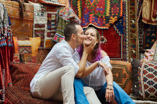 Canvas Print Couple in love chooses a Turkish carpet at the market