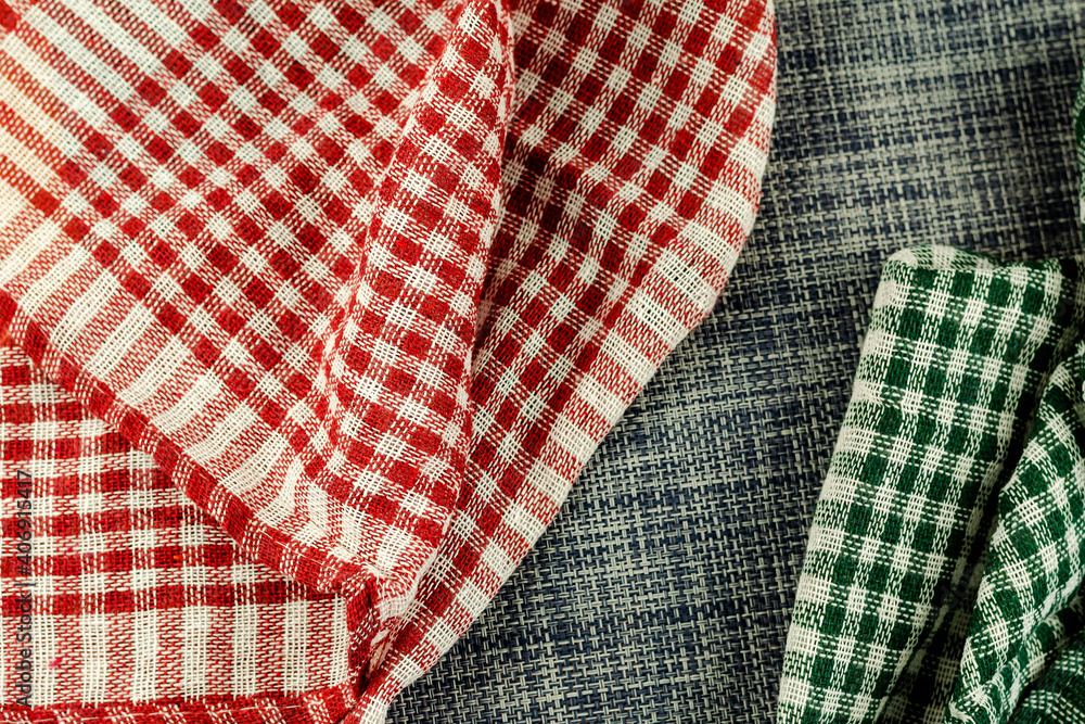 Red and green checkered blue denim cloth napkin.
