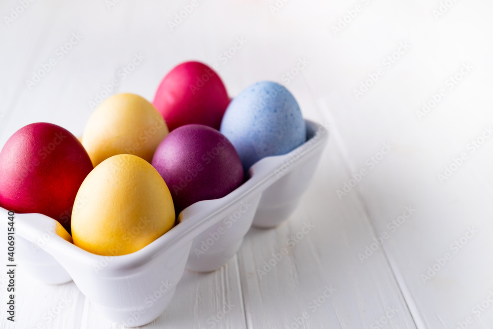 Multicolor eggs in a white tray. Minimal concept Multicolor eggs in a white tray. Minimal concept