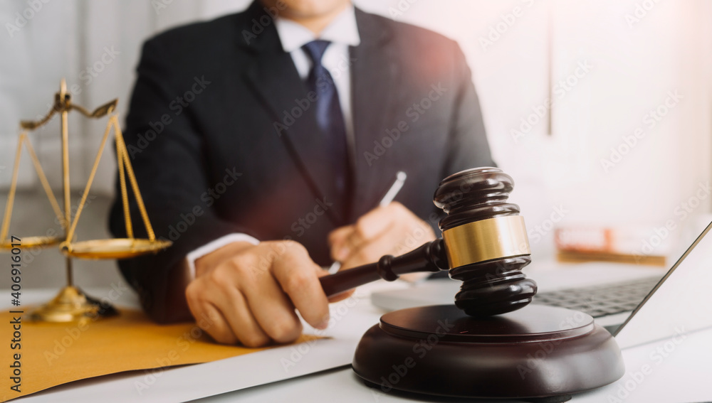 justice and law concept.Male judge in a courtroom on wooden table and Counselor or Male lawyer working in office. Legal law, advice and justice concept. justice and law concept.Male judge in a courtroom on wooden table and Counselor or Male lawyer working in office. Legal law, advice and justice concept.