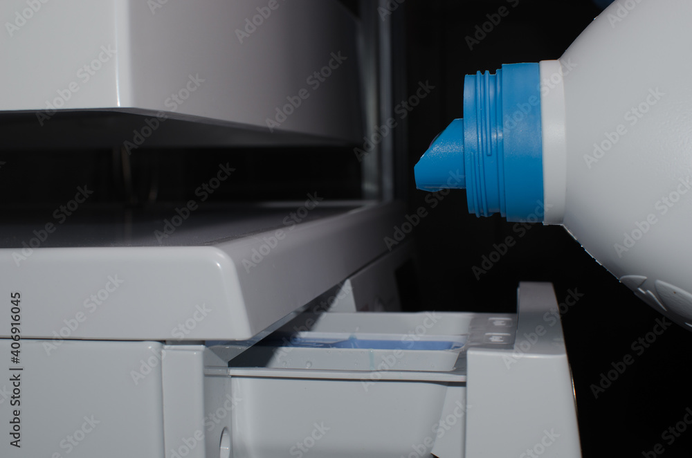 Liquid powder is poured into a special container in the washing machine. Washing dirty laundry Liquid powder is poured into a special container in the washing machine. Washing dirty laundry