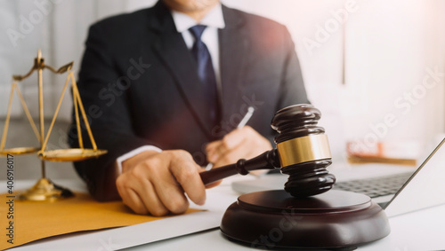 justice and law concept.Male judge in a courtroom on wooden table and Counselor or Male lawyer working in office. Legal law, advice and justice concept.