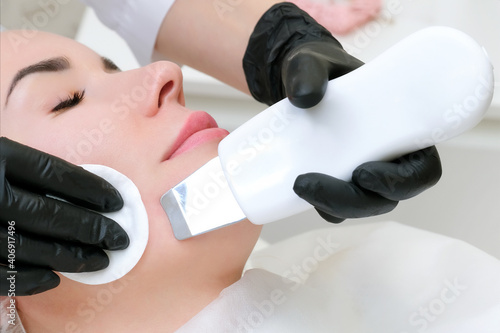 ultrasonic cleaning of the face of a young woman