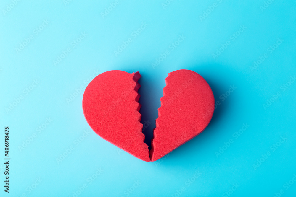 Broken heart on a colored background. Unhappy love, betrayal, quarrel, breakup concept. Broken heart on a colored background. Unhappy love, betrayal, quarrel, breakup concept.