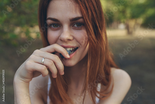 portrait of happy woman outdoors in garden and trees summer vacation enjoyment