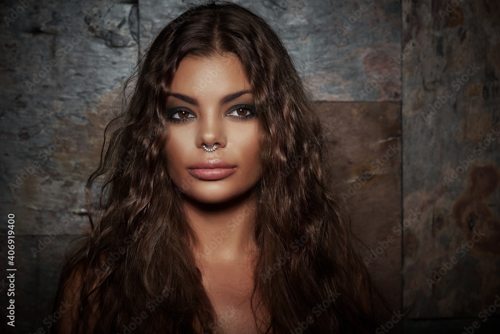 Studio portrait of latin american woman with nose piercing. Studio portrait of latin american woman with nose piercing.