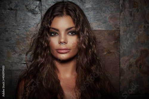 Foto Studio portrait of latin american woman with nose piercing.