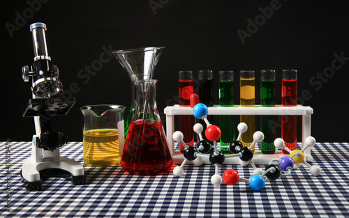 Science Education concpet, laboratory glassware with solustion and microscope photo