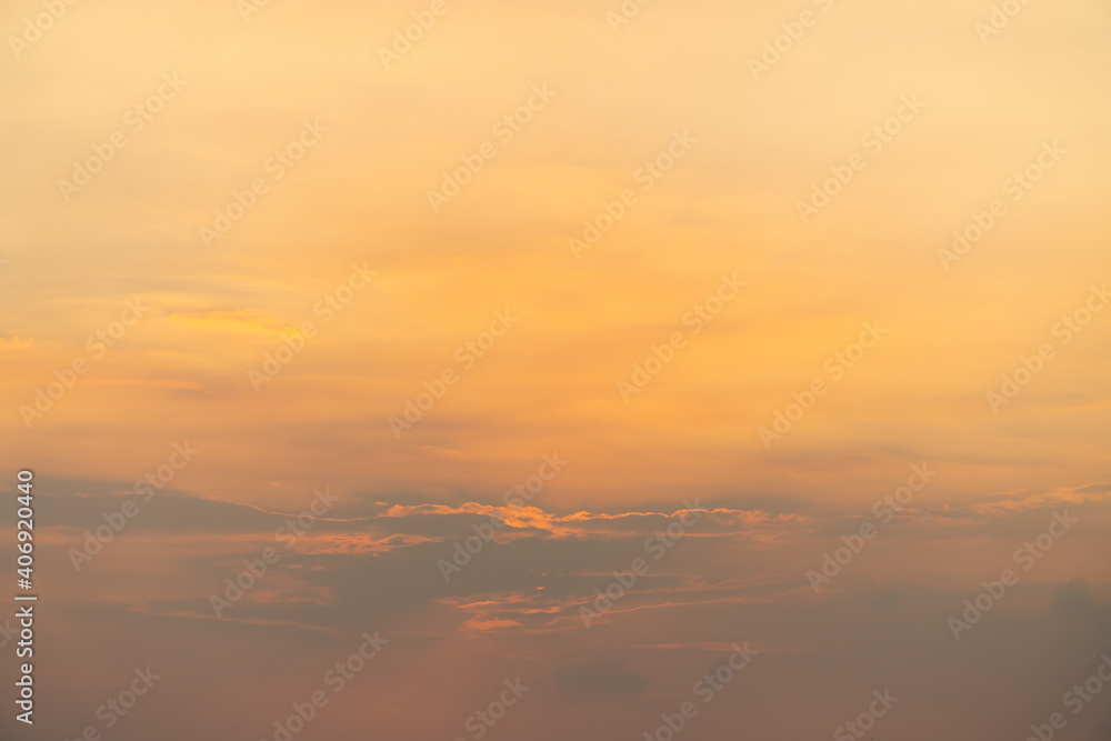 Beautiful pastel sky with golden clouds pattern in a holiday evening for background or wallpaper. Sunset sky. Twilight scene.