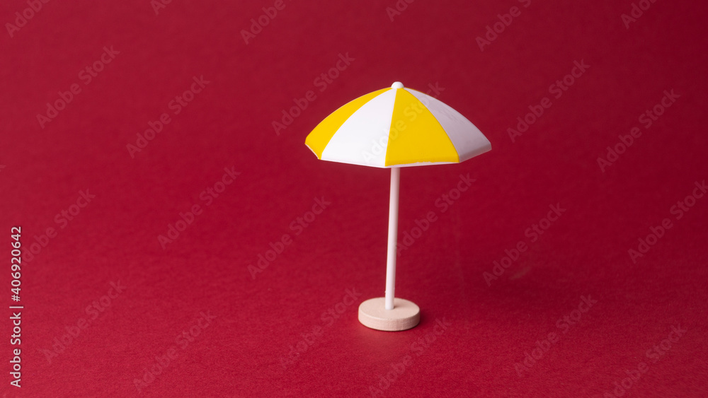 colorful beach umbrella on red background