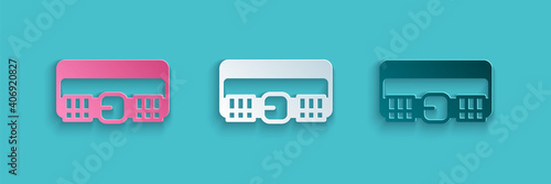 Paper cut Hunting cartridge belt with cartridges icon isolated on blue background. Bandolier sign. Hunter equipment, armament. Paper art style. Vector.