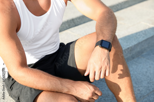 Man with fitness tracker after training outdoors  closeup