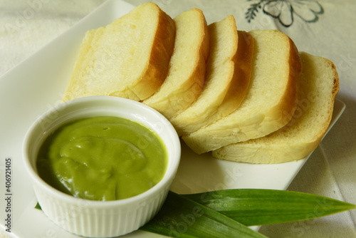 Homemade fresh Thai pandanus leaf custard with bread. photo