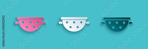 Paper cut Kitchen colander icon isolated on blue background. Cooking utensil. Cutlery sign. Paper art style. Vector.