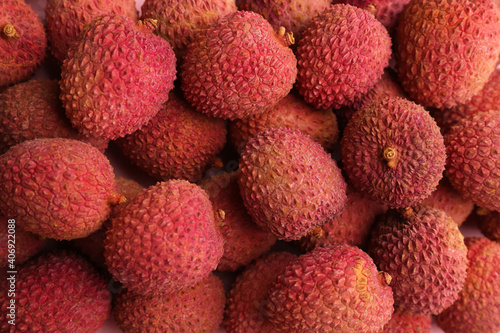 Pile of fresh ripe lychees as background, top view