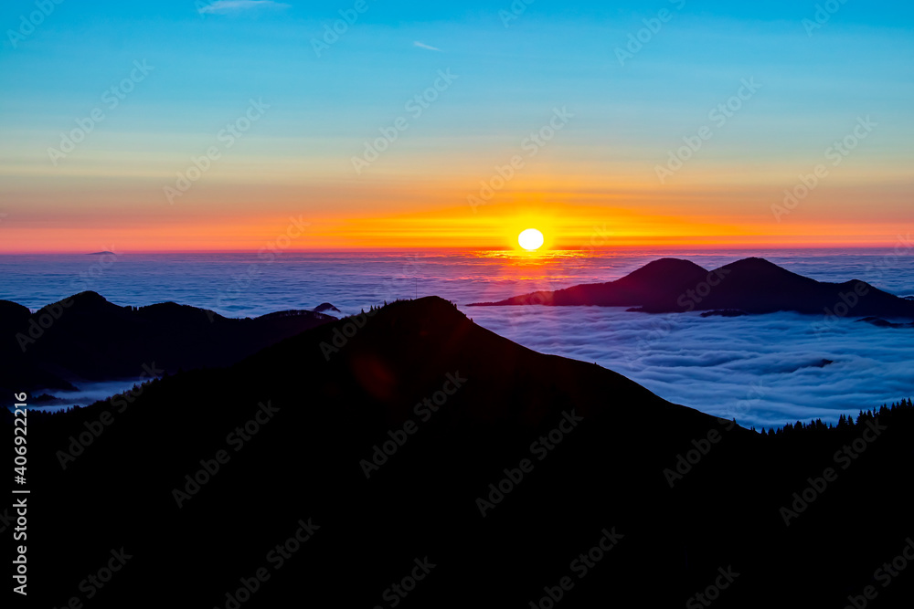 Sunrise with sea of clouds in horizon	