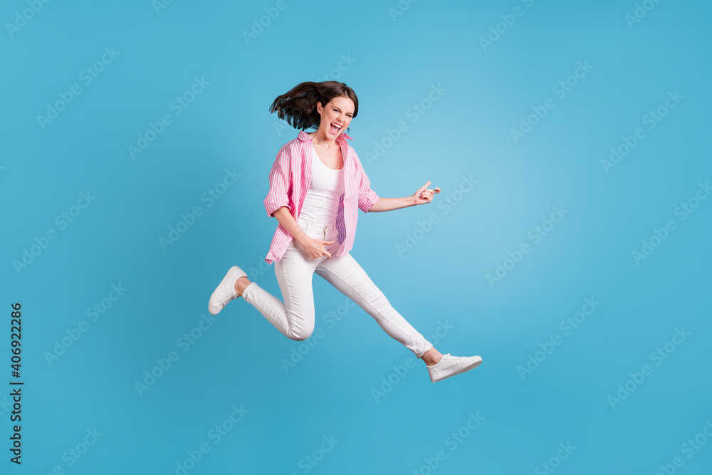Full size photo of attractive lady jump hands play guitar imagine open mouth isolated on blue color background
