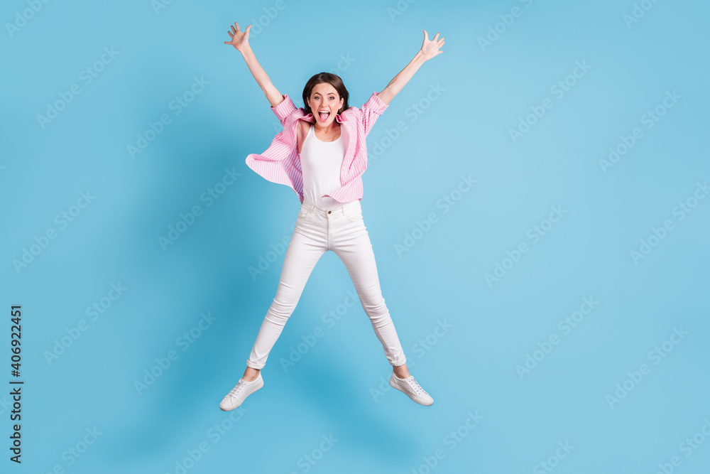 Full body photo of impressed cheerful lady jump high star figure open mouth isolated on blue color background Full body photo of impressed cheerful lady jump high star figure open mouth isolated on blue color background