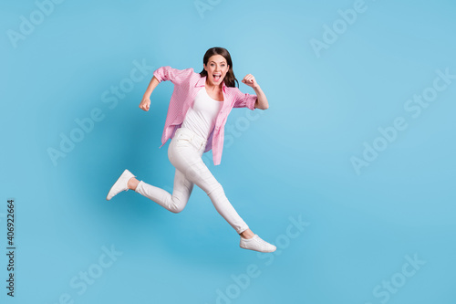 Fototapeta Naklejka Na Ścianę i Meble -  Full length portrait of cheerful person jump run hurry open mouth good mood isolated on blue color background