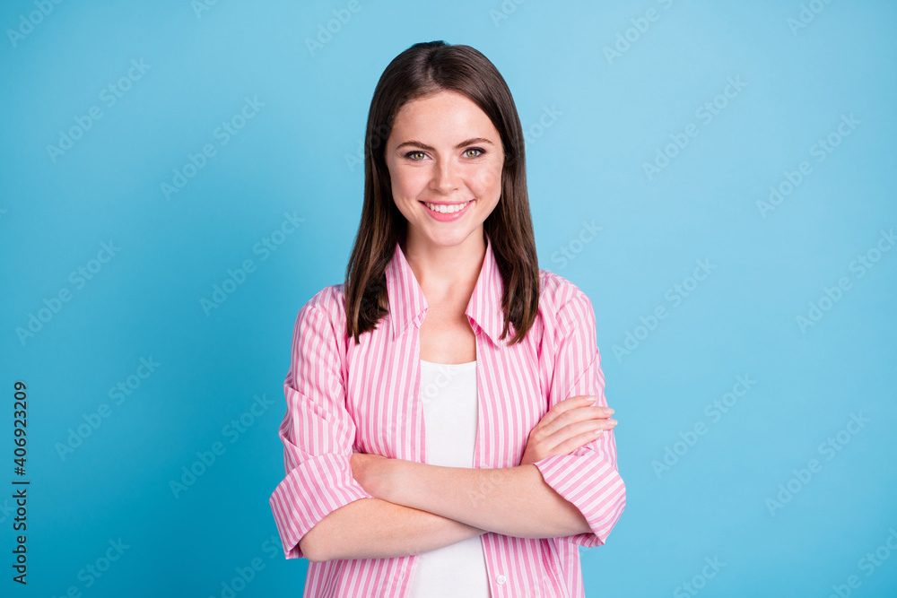 Photo portrait of confident woman with crossed arms isolated on pastel blue colored background Photo portrait of confident woman with crossed arms isolated on pastel blue colored background