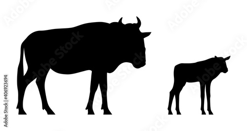Black silhouettes of standing wildebeest and calf isolated on white background. Vector illustration