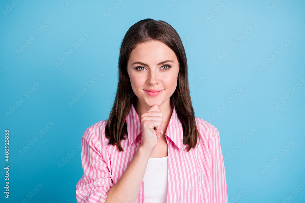 Photo portrait of clever woman touching face chin with finger isolated on pastel blue colored background Photo portrait of clever woman touching face chin with finger isolated on pastel blue colored background