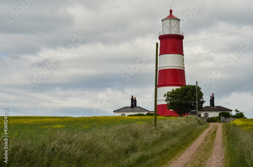 Foto Happisburgh lighthouse against cloudy sky.