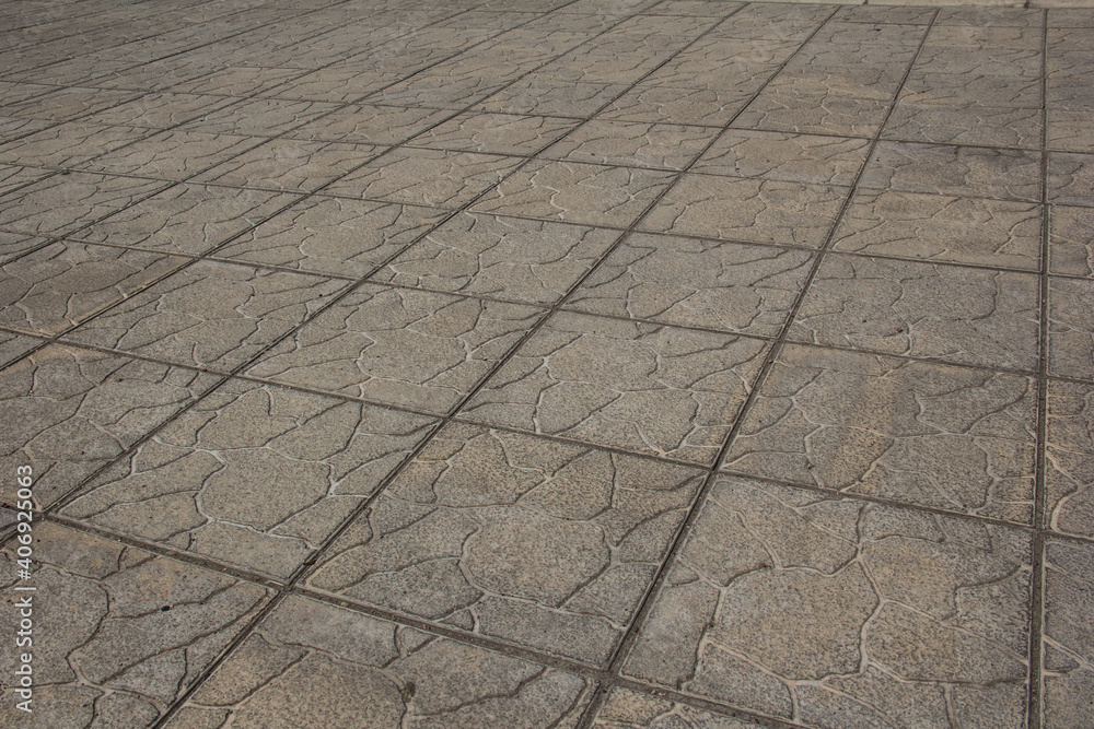 Fototapeta premium The sidewalk is paved with square decorative tiles.